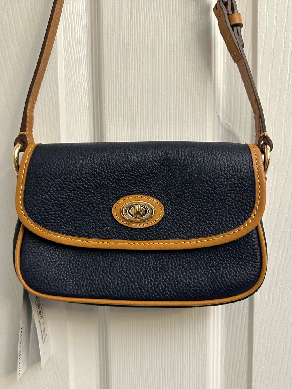 Dooney & Bourke Navy and Tan Pebbled Leather Crossbody With Turn Lock Closure